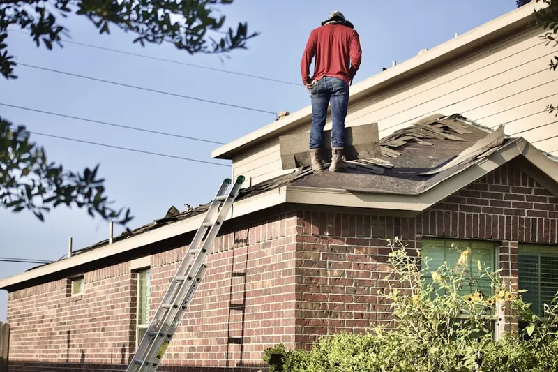 Professional roofer working on a residential roof in Spring Oaks